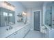 Modern bathroom with double vanities, framed mirrors, and a glass-enclosed shower at 1543 Watoga Way, Mount Pleasant, SC 29466