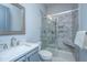 Modern bathroom featuring a marble-tiled shower with glass door and brushed nickel fixtures at 1543 Watoga Way, Mount Pleasant, SC 29466