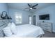 Bright bedroom featuring a whitewashed wood-frame bed, flatscreen TV, and balcony access at 1543 Watoga Way, Mount Pleasant, SC 29466