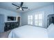 A bright bedroom with white bedding, dark furniture, and white shutters on the windows at 1543 Watoga Way, Mount Pleasant, SC 29466