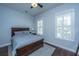 Cozy bedroom with a wood-framed bed, ceiling fan, and natural light from the window at 1543 Watoga Way, Mount Pleasant, SC 29466