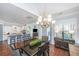 This beautiful dining area offers hardwood floors, a modern light fixture, and access to the kitchen at 1543 Watoga Way, Mount Pleasant, SC 29466