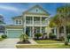 Charming two-story home featuring a double porch, aqua-colored siding, and well-maintained landscaping at 1543 Watoga Way, Mount Pleasant, SC 29466
