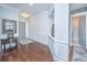 Elegant foyer featuring hardwood floors, wainscoting, stylish decor, and seamless access to different areas of the home at 1543 Watoga Way, Mount Pleasant, SC 29466