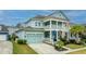 Charming two-story home with a double porch, two-car garage, green lawn and driveway at 1543 Watoga Way, Mount Pleasant, SC 29466
