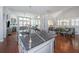 Open-concept kitchen featuring an island with a sink, seamlessly connecting to the dining area and living room at 1543 Watoga Way, Mount Pleasant, SC 29466