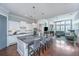 Modern kitchen with a large island, granite countertops, white cabinetry, and an open view to the living room at 1543 Watoga Way, Mount Pleasant, SC 29466