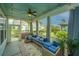 Inviting screened-in patio with comfortable seating, string lights, and fan at 1543 Watoga Way, Mount Pleasant, SC 29466