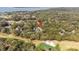 An aerial shot captures the property among lush trees, near a golf course and ocean at 157 High Hammock Villas, Seabrook Island, SC 29455