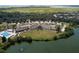Picturesque aerial view of the community featuring the clubhouse, lake, surrounding nature, and nearby waterway at 157 High Hammock Villas, Seabrook Island, SC 29455