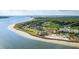 A scenic aerial view features a resort community on the beach, surrounded by lush greenery at 157 High Hammock Villas, Seabrook Island, SC 29455