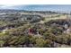 Overhead shot reveals the property, bordered by a green golf course and beach at 157 High Hammock Villas, Seabrook Island, SC 29455