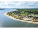 Breathtaking aerial view of the coastal community, highlighting the beach, golf course, and residential areas at 157 High Hammock Villas, Seabrook Island, SC 29455