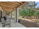 View of the outdoor patio seating area beneath the deck, surrounded by a lush, natural landscape at 157 High Hammock Villas, Seabrook Island, SC 29455