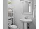 Clean half-bathroom with pedestal sink and nearby shelving at 157 High Hammock Villas, Seabrook Island, SC 29455