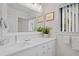 Bright bathroom featuring white cabinets, quartz countertops, a large mirror and a decorative plant at 157 High Hammock Villas, Seabrook Island, SC 29455