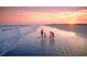 Stunning sunset view of a Gathering walking on the beach, highlighting the natural beauty of the coastal setting at 157 High Hammock Villas, Seabrook Island, SC 29455