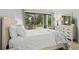 Cozy bedroom with a large window view of the backyard and neutral decor at 157 High Hammock Villas, Seabrook Island, SC 29455