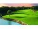 Beautiful golf course view with a calm lake surrounded by grass and tall trees at 157 High Hammock Villas, Seabrook Island, SC 29455