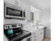Updated kitchen features stainless steel appliances, white cabinets, and modern finishes at 157 High Hammock Villas, Seabrook Island, SC 29455