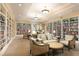 Bright and inviting library with floor-to-ceiling bookshelves and comfortable seating areas at 157 High Hammock Villas, Seabrook Island, SC 29455