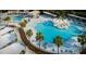 Aerial view of a luxurious pool area with palm trees, lounge chairs, and shaded cabanas at 157 High Hammock Villas, Seabrook Island, SC 29455