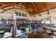 Spacious restaurant with vaulted wood ceilings, blue booth seating and large windows providing ample natural light at 157 High Hammock Villas, Seabrook Island, SC 29455