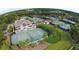 Aerial view of tennis courts surrounded by lush landscaping, creating a perfect setting for outdoor activities at 157 High Hammock Villas, Seabrook Island, SC 29455