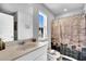 Well-lit bathroom featuring a large mirror, vanity, and a shower-tub combination with a modern shower curtain at 157 Tuscan Sun St, Summerville, SC 29485