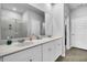 Modern bathroom with double sinks, a large mirror, white cabinets, and a glass-enclosed shower at 157 Tuscan Sun St, Summerville, SC 29485