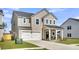 Beautiful two-story house with a well-manicured lawn, attached garage, and a welcoming front porch with seating at 157 Tuscan Sun St, Summerville, SC 29485