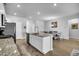 Bright kitchen features an island, stainless steel appliances, and hardwood floors at 157 Tuscan Sun St, Summerville, SC 29485