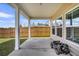 Covered patio area with white columns and a toy car parked to the side, adjacent to a lawn and a fence at 157 Tuscan Sun St, Summerville, SC 29485