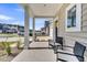 Inviting front porch featuring comfortable seating and views of the neighborhood landscape at 157 Tuscan Sun St, Summerville, SC 29485