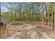 A large backyard featuring a trampoline, basketball goal, and trees at 158 Dean Dr, Summerville, SC 29483