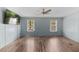 Bedroom with wood-look floors, two windows, a ceiling fan and a wall-mounted television at 158 Dean Dr, Summerville, SC 29483