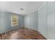 A bright bedroom featuring wood-look floors, a window and light blue walls at 158 Dean Dr, Summerville, SC 29483
