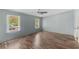 Well-lit bedroom boasting wood-look floors, two windows, light blue walls and a ceiling fan at 158 Dean Dr, Summerville, SC 29483