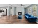 Bright living room features a fireplace, wood floors, and comfortable blue velvet seating at 158 Dean Dr, Summerville, SC 29483