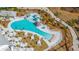 Aerial view of a resort-style pool with lounge chairs, cabanas, and a surrounding wooded area at 159 Garden Gate Way, Summerville, SC 29486