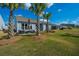 View of the backyard featuring palm trees and green grass at 159 Garden Gate Way, Summerville, SC 29486