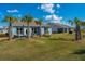 View of the backyard featuring palm trees and green grass at 159 Garden Gate Way, Summerville, SC 29486