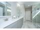Modern bathroom with double sinks, a large mirror, and a stylish walk-in shower at 159 Garden Gate Way, Summerville, SC 29486