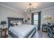 Comfortable bedroom with decorative lighting, curtains, and a plush bed with patterned pillows at 159 Garden Gate Way, Summerville, SC 29486