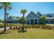 Inviting clubhouse with a charming exterior, featuring palm trees and lush landscaping at 159 Garden Gate Way, Summerville, SC 29486