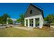 Community entrance featuring a modern architectural design with gray wood and white pillars at 159 Garden Gate Way, Summerville, SC 29486