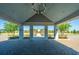 View of a paved entrance with lush landscaping leading to a building with palm trees at 159 Garden Gate Way, Summerville, SC 29486