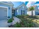 Inviting front entrance with a charming door, decorative wreath, and lush landscaping with colorful flowers at 159 Garden Gate Way, Summerville, SC 29486