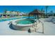Outdoor hot tub with a pergola nearby, surrounded by lush landscaping and the pool at 159 Garden Gate Way, Summerville, SC 29486