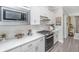 Modern kitchen with sleek white countertops, stainless steel appliances, and subway tile backsplash, perfect for cooking at 159 Garden Gate Way, Summerville, SC 29486